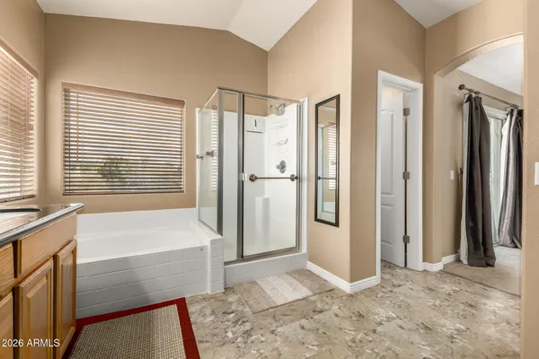 a bathroom with a tub shower and a sink