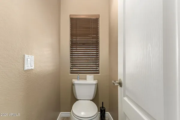 a white toilet sitting next to a shower