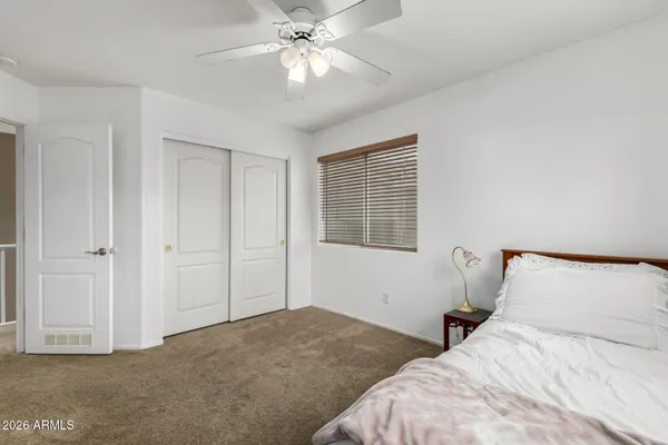 a bedroom with bed and window