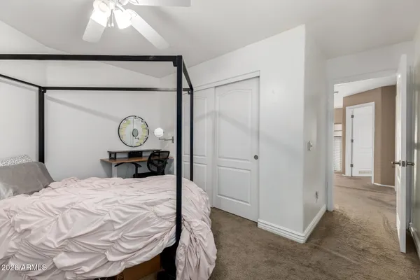 a bed room with a bed and a mirror