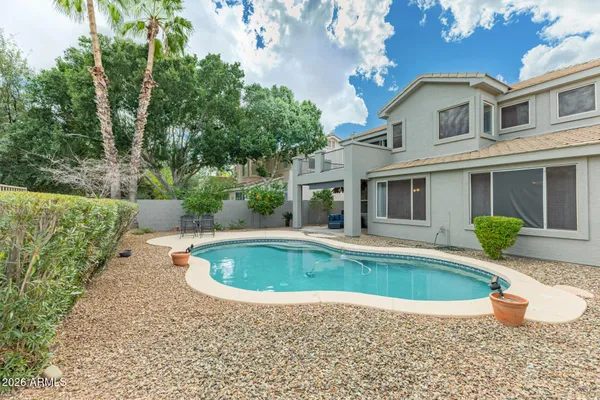 a view of a house with swimming pool and sitting area