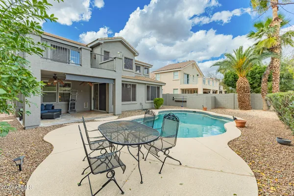 a view of a house with swimming pool and sitting area