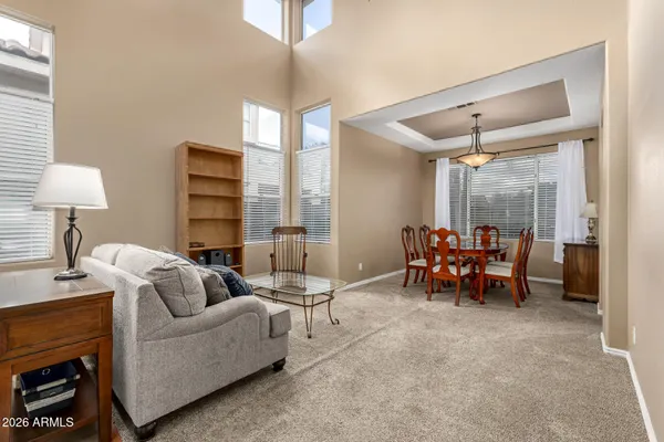 a living room with furniture and a lamp