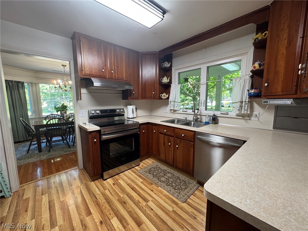 296 Fairfield Road Painesville, OH 44077 - Photo 16 of 48 Kitchen featuring stainless steel appliances, cherry wood cabinetry and a double basin sink beneath a window overlooking the front entry