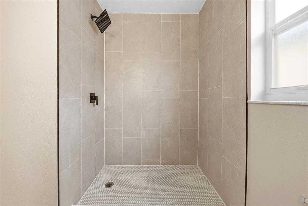 245 Hollinghead Loop Davenport, FL 33896 - Photo 15 of 19 a bathroom with a shower