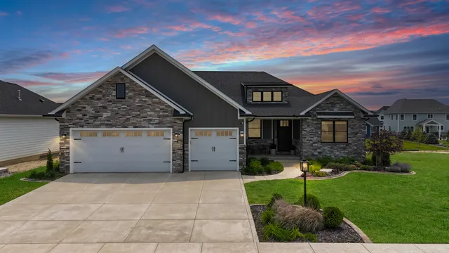 a front view of a house with a yard and garage