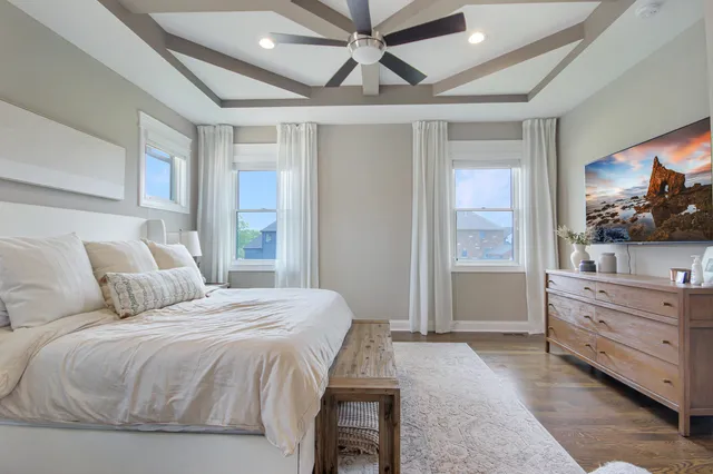 a bedroom with a large bed and a window