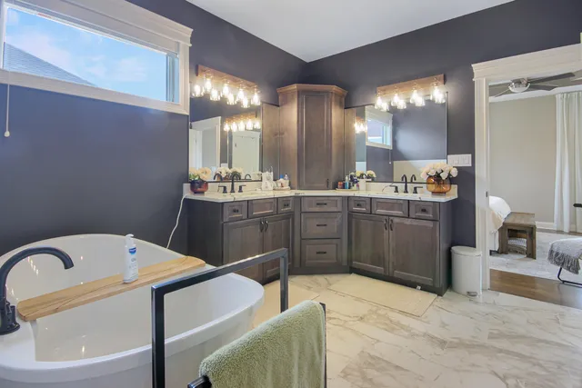 a kitchen with a sink a stove and chairs