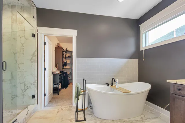 a bathroom with a bathtub and shower