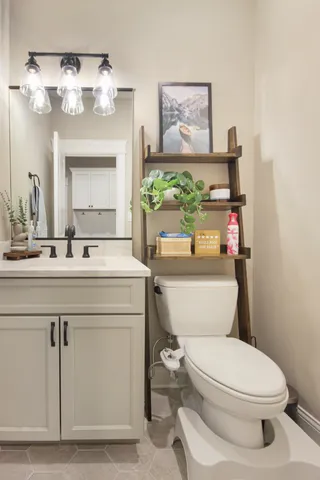 a bathroom with a sink a mirror and a toilet