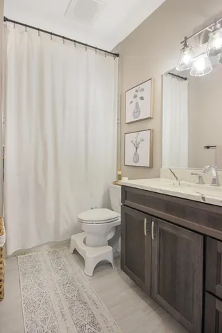 a bathroom with a toilet a sink and a mirror