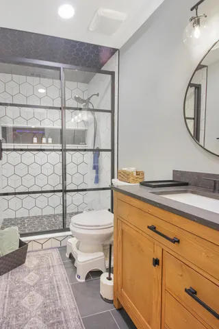 a bathroom with a toilet a sink and shower