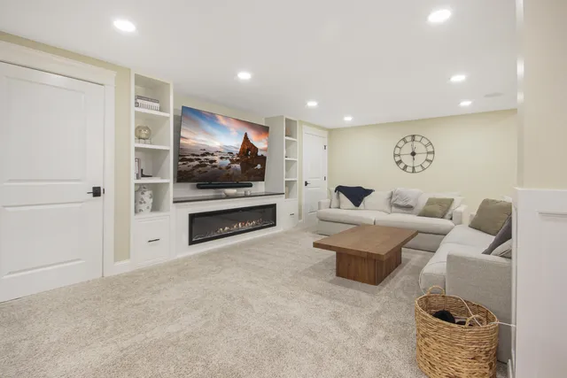a living room with furniture a fireplace and a flat screen tv