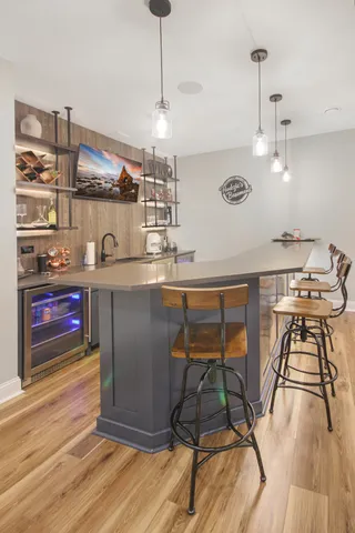 a kitchen with stainless steel appliances granite countertop a stove a sink and a wooden floors