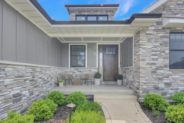 a view of front door of house with outdoor seating