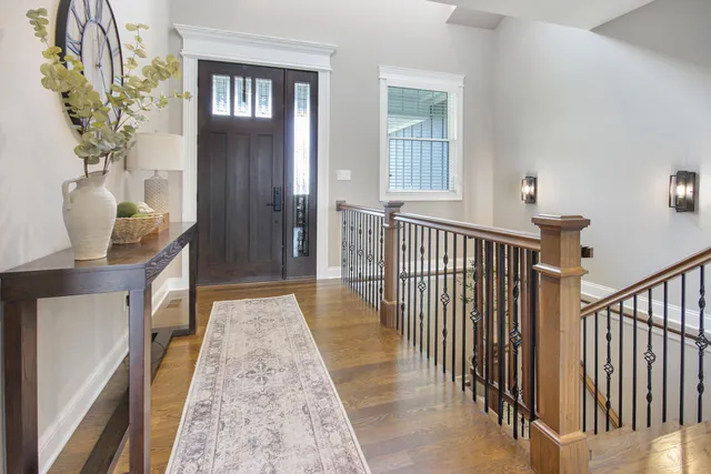 a view of a hallway to a livingroom with furniture