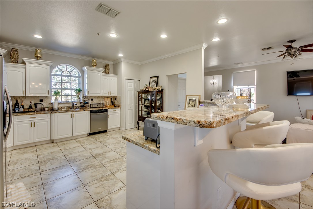 6091 Park Road Fort Myers, FL 33908 - Photo 4 of 22 a living room with stainless steel appliances kitchen island granite countertop furniture and a kitchen view