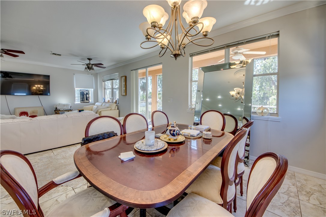 6091 Park Road Fort Myers, FL 33908 - Photo 5 of 22 a dining room with furniture a chandelier and window