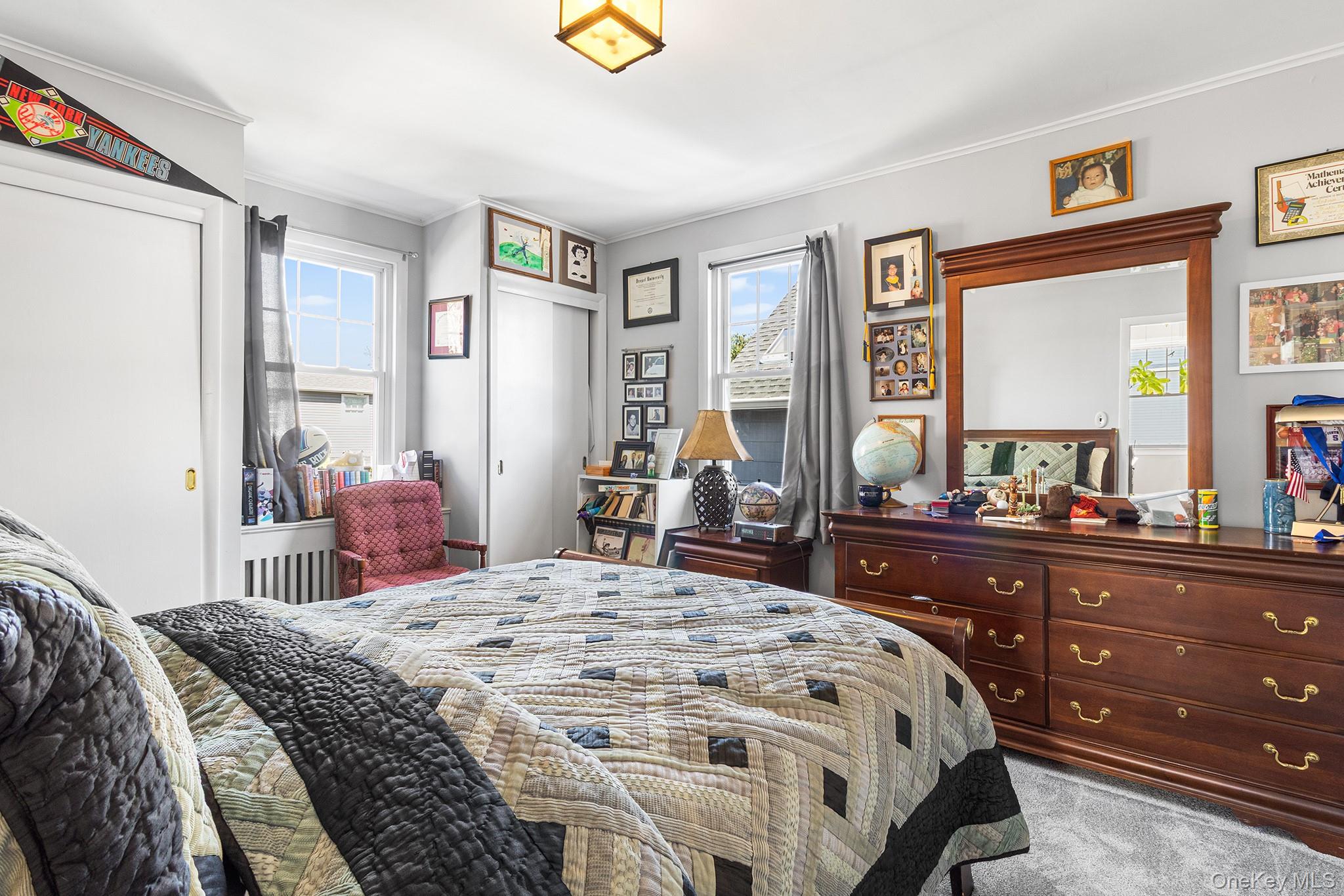 46 Riggs Place Locust Valley, NY 11560 - Photo 24 of 29 a bedroom with a bed and wooden floor