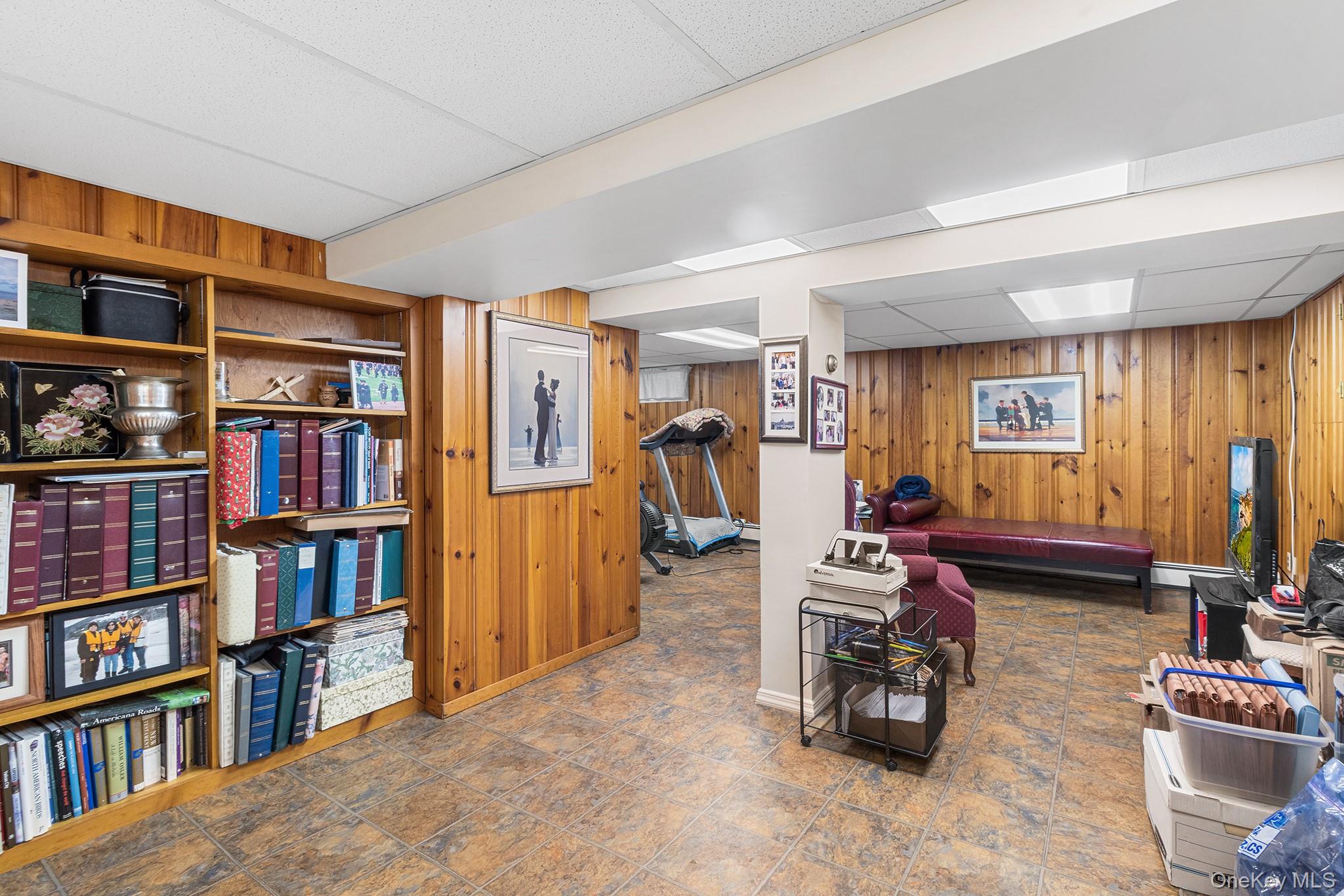 46 Riggs Place Locust Valley, NY 11560 - Photo 26 of 29 a living room with furniture and a book shelf
