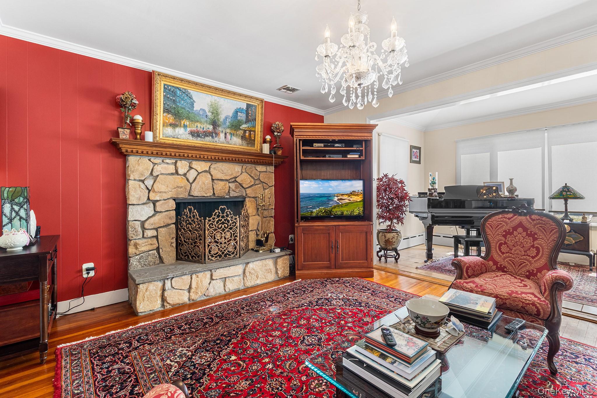 46 Riggs Place Locust Valley, NY 11560 - Photo 3 of 29 a living room with furniture a chandelier and a rug
