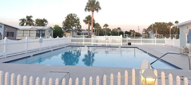 a view of a balcony with floor to ceiling windows and wooden fence