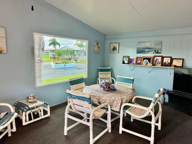 a dining room with furniture and a window