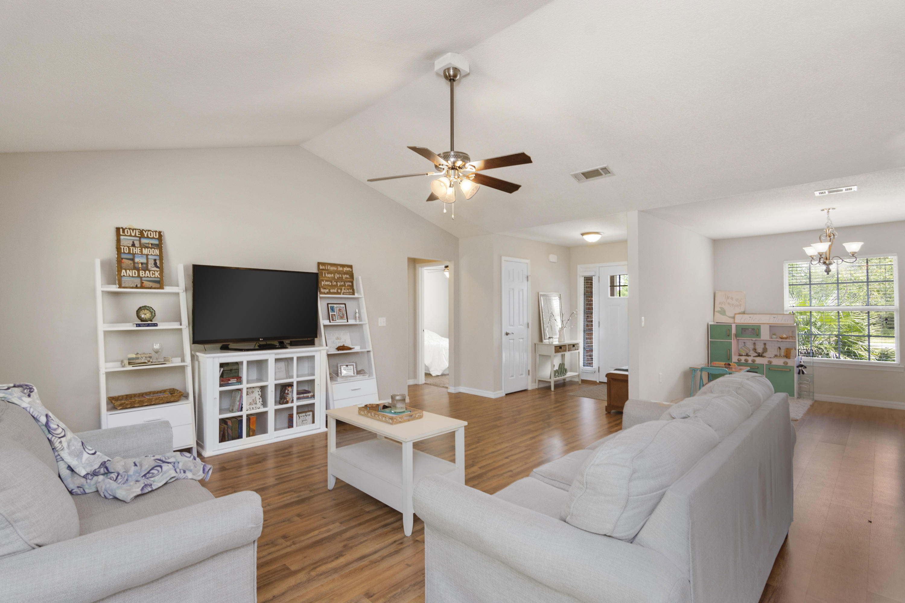 6336 Possum Ridge Road Crestview, FL 32539 - Photo 13 of 40 a living room with furniture and a flat screen tv