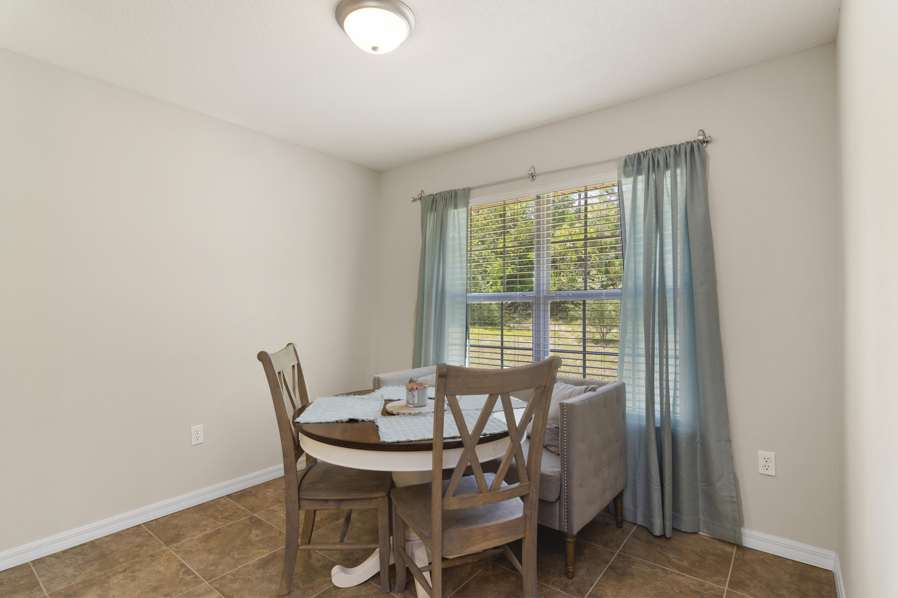 6336 Possum Ridge Road Crestview, FL 32539 - Photo 18 of 40 a view of a dining room with furniture and wooden floor