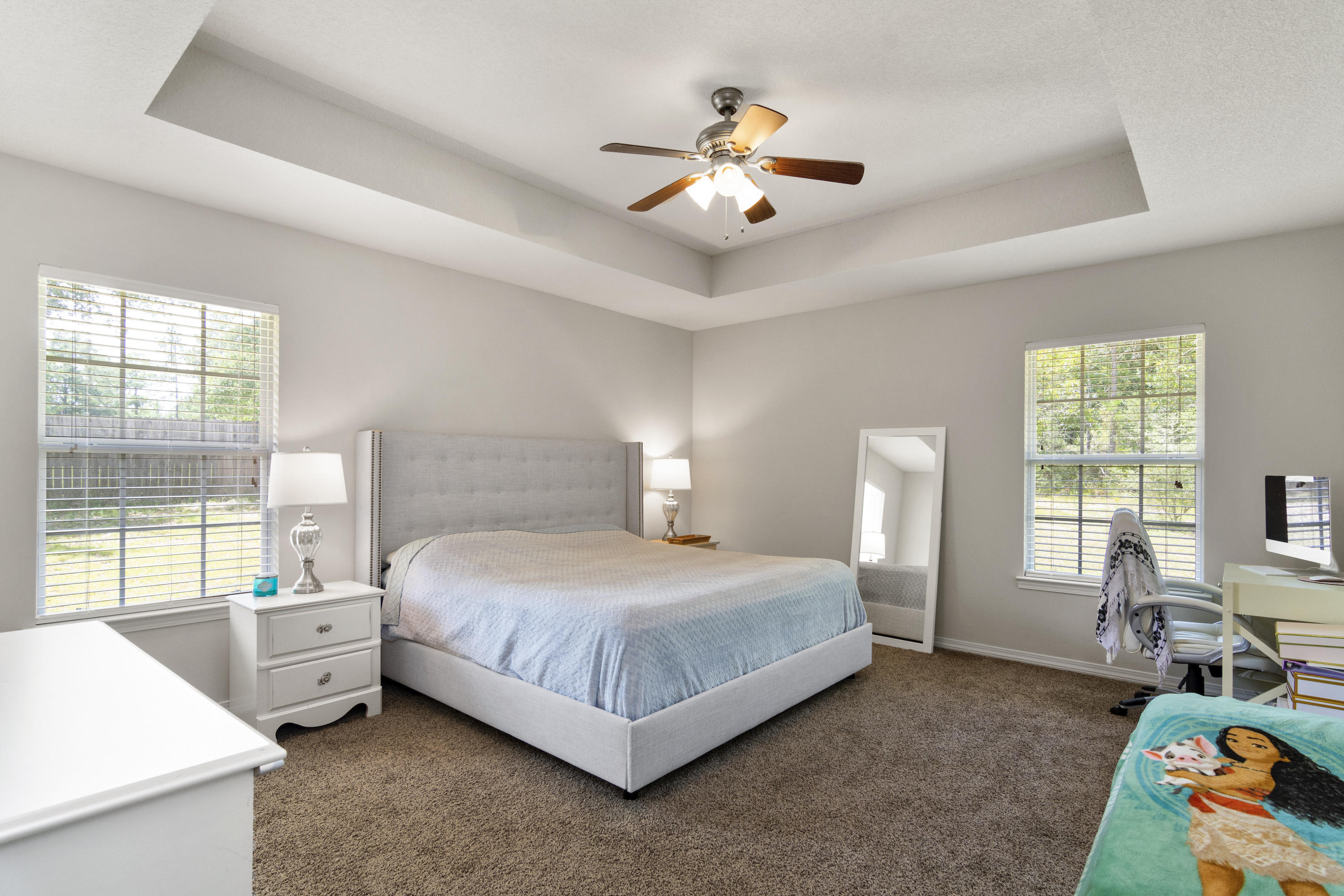6336 Possum Ridge Road Crestview, FL 32539 - Photo 19 of 40 a bedroom with a bed a chandelier and a window