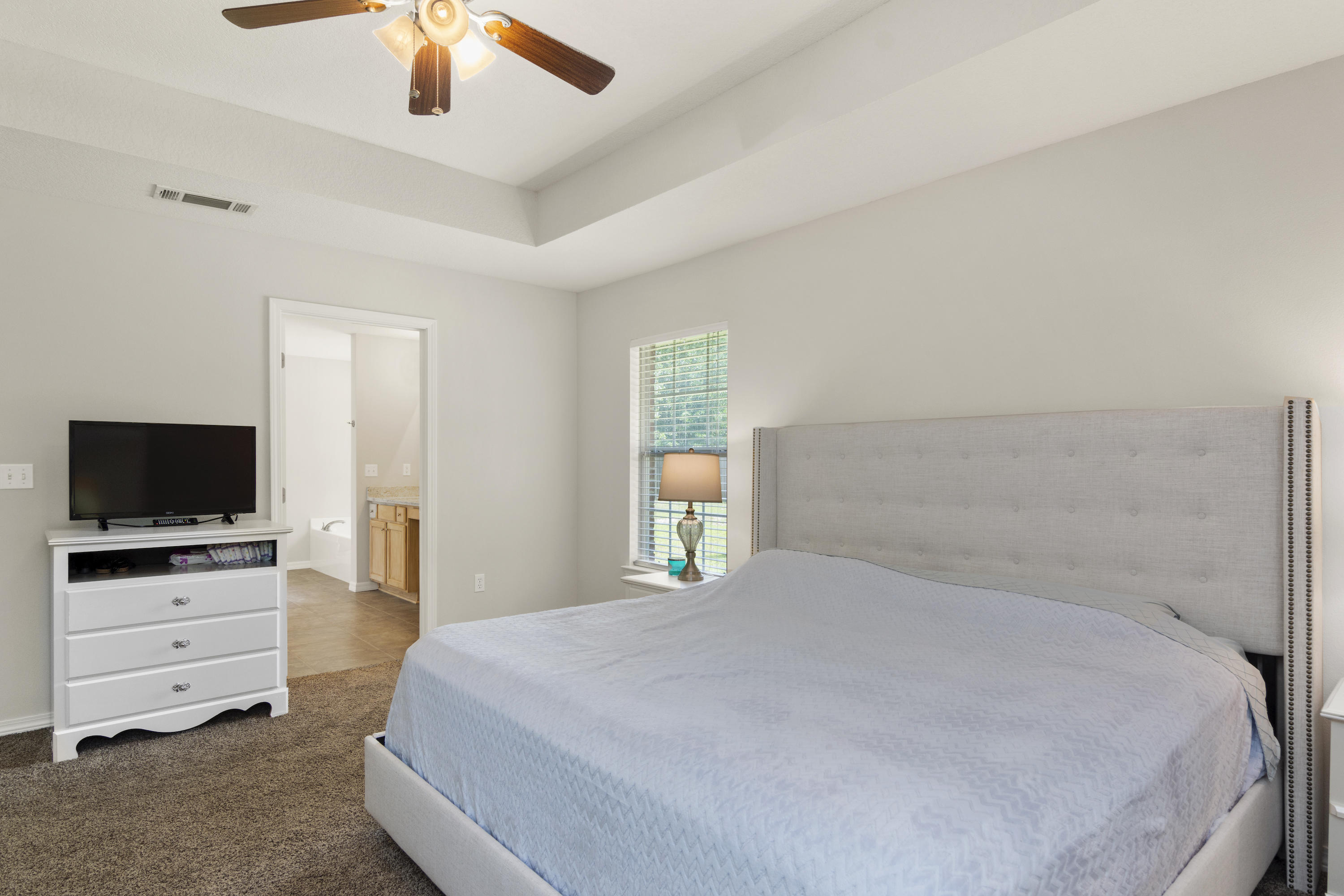 6336 Possum Ridge Road Crestview, FL 32539 - Photo 20 of 40 a bedroom with a bed and a flat screen tv