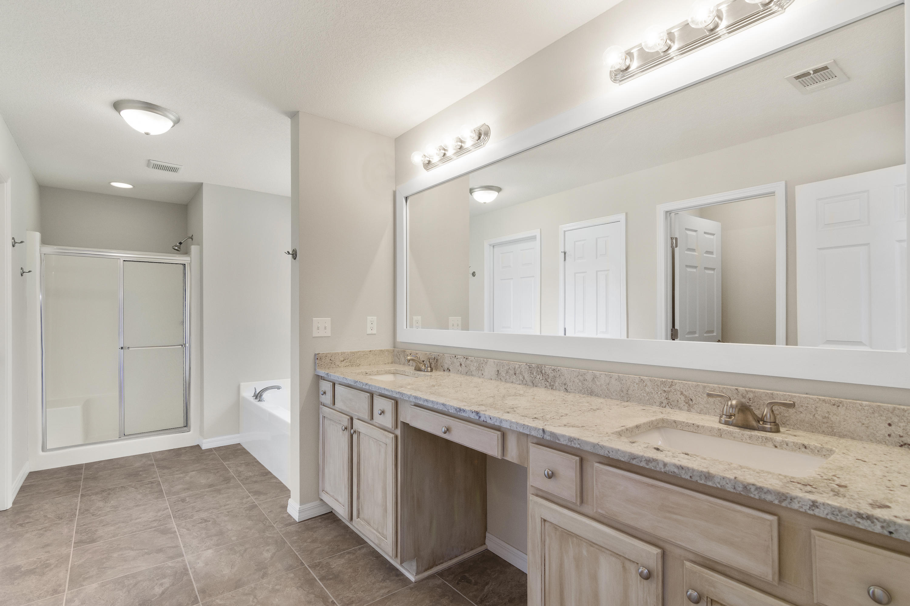 6336 Possum Ridge Road Crestview, FL 32539 - Photo 21 of 40 a bathroom with a granite countertop sink and a mirror