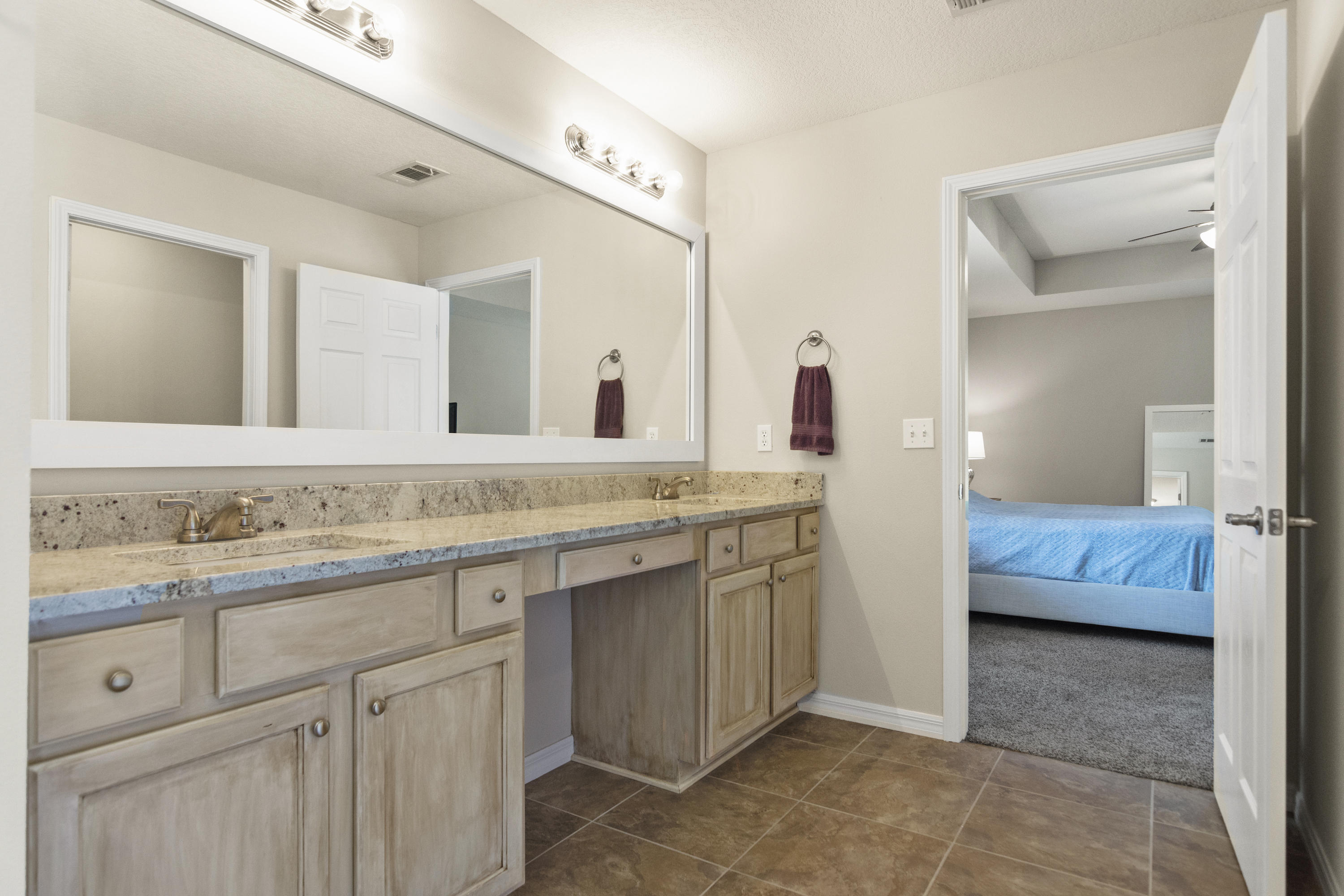 6336 Possum Ridge Road Crestview, FL 32539 - Photo 24 of 40 a en suite bathroom with a double vanity sink and a mirror