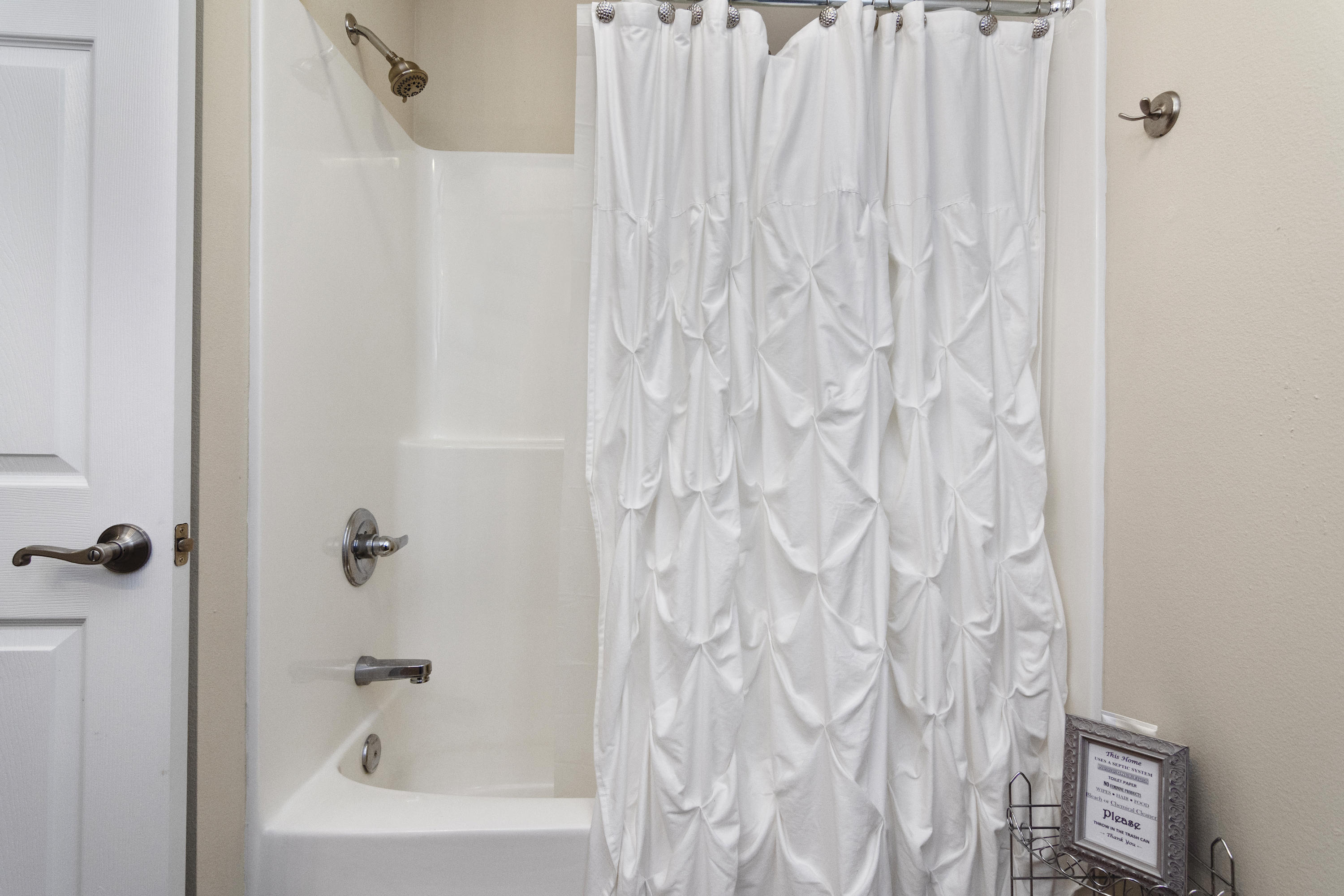 6336 Possum Ridge Road Crestview, FL 32539 - Photo 27 of 40 a bathroom with a shower curtain and a bathtub