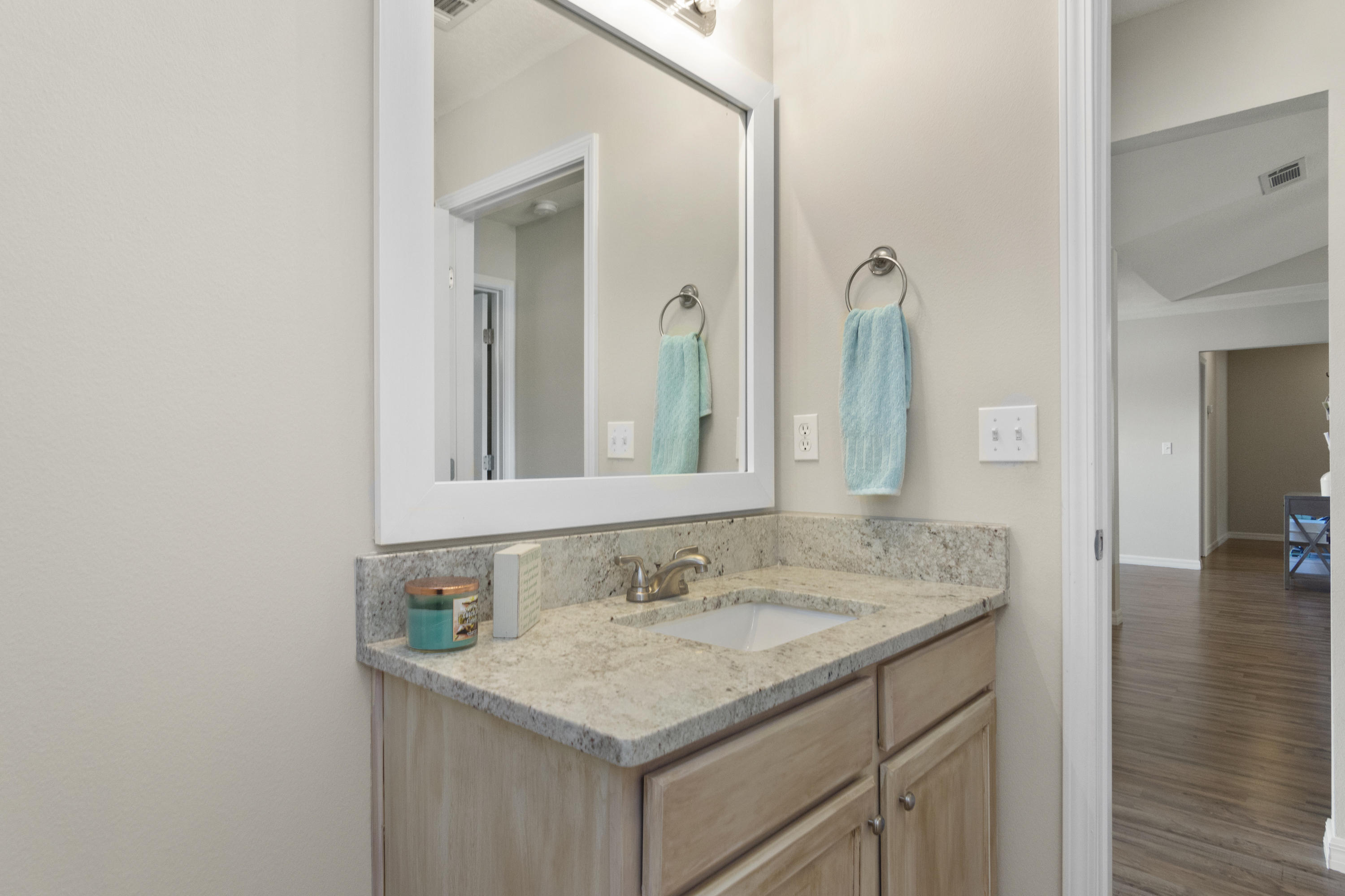 6336 Possum Ridge Road Crestview, FL 32539 - Photo 28 of 40 a bathroom with a granite countertop sink and a mirror