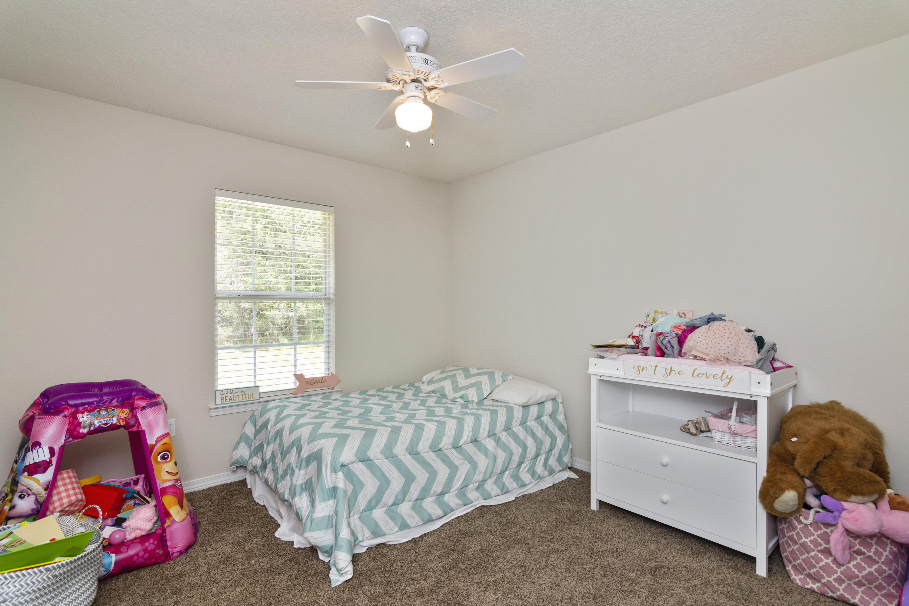 6336 Possum Ridge Road Crestview, FL 32539 - Photo 29 of 40 a bedroom with a bed and a chandelier