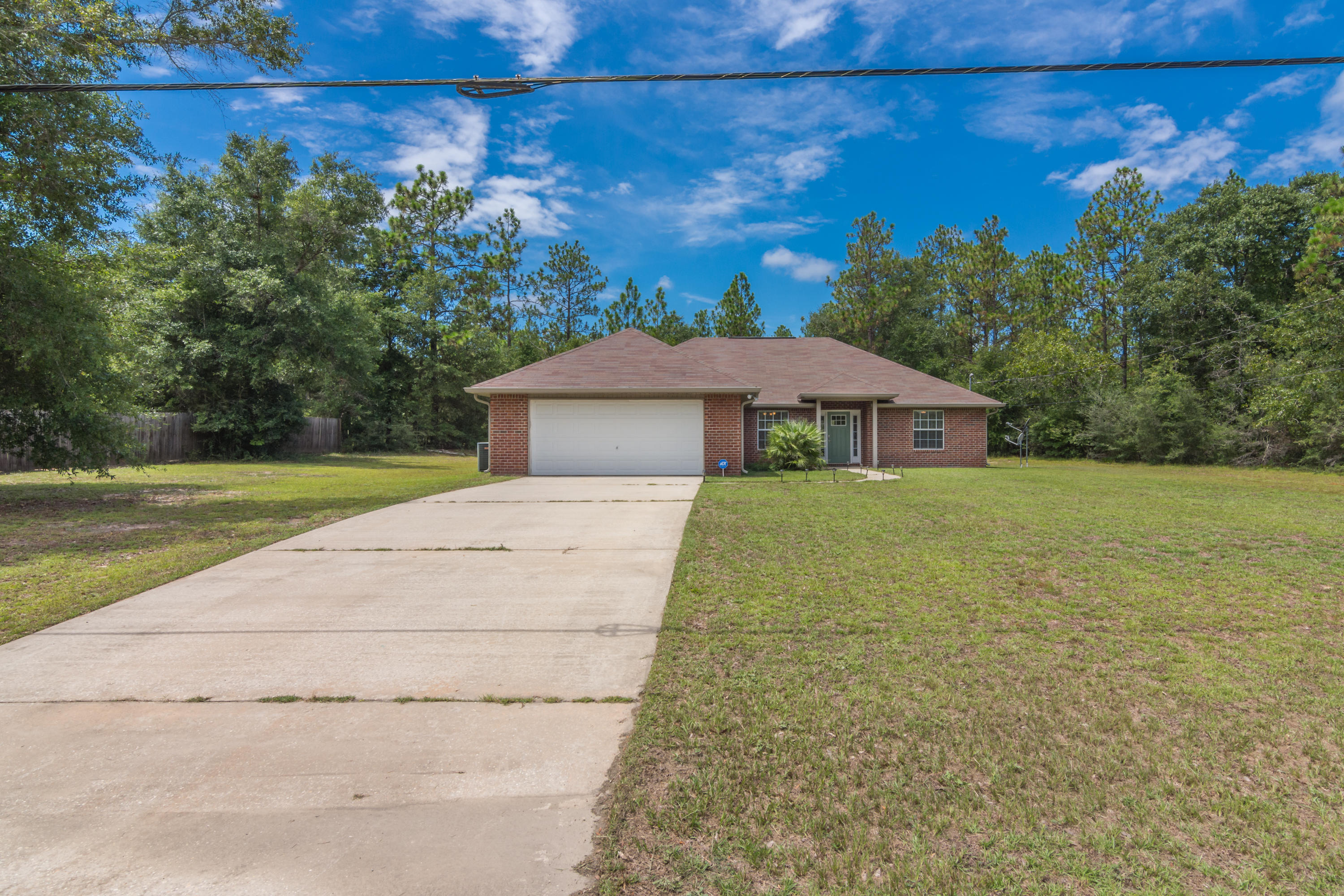 6336 Possum Ridge Road Crestview, FL 32539 - Photo 3 of 40 a front view of a house with garden