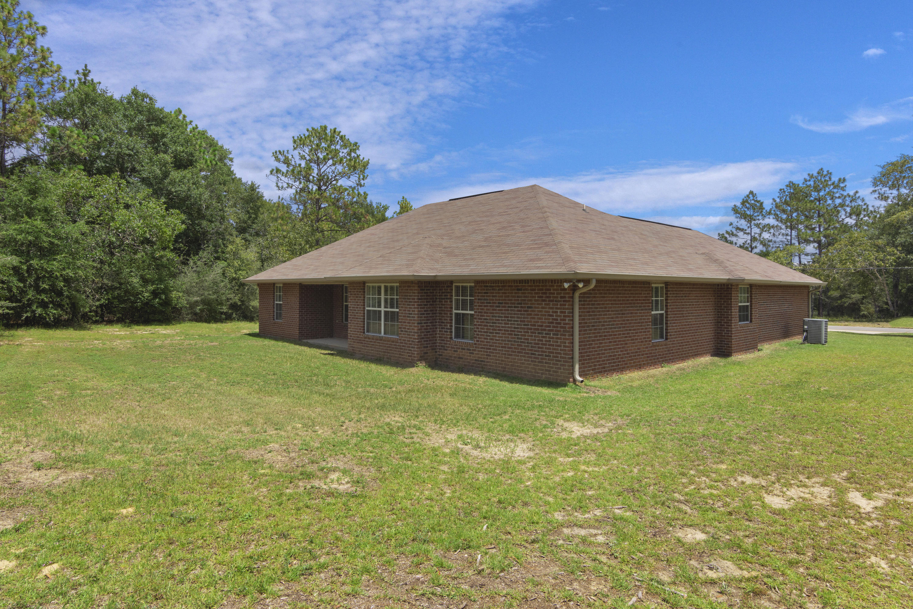 6336 Possum Ridge Road Crestview, FL 32539 - Photo 32 of 40 a house with green field in front of it