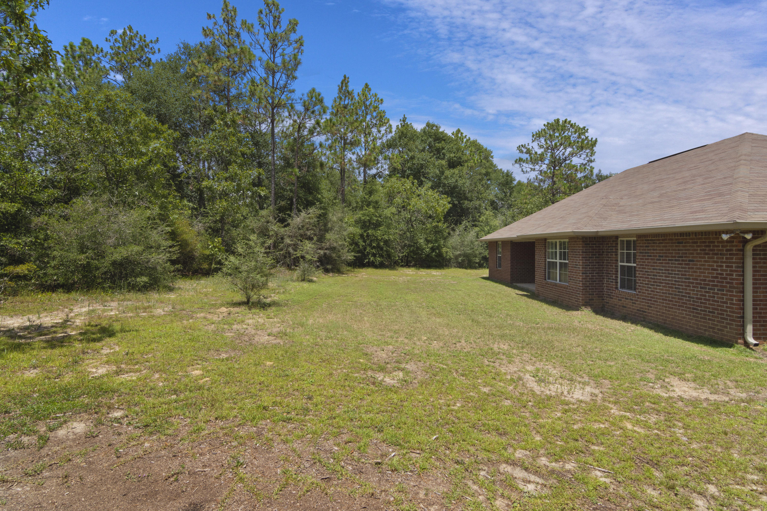 6336 Possum Ridge Road Crestview, FL 32539 - Photo 33 of 40 a yellow house with a yard