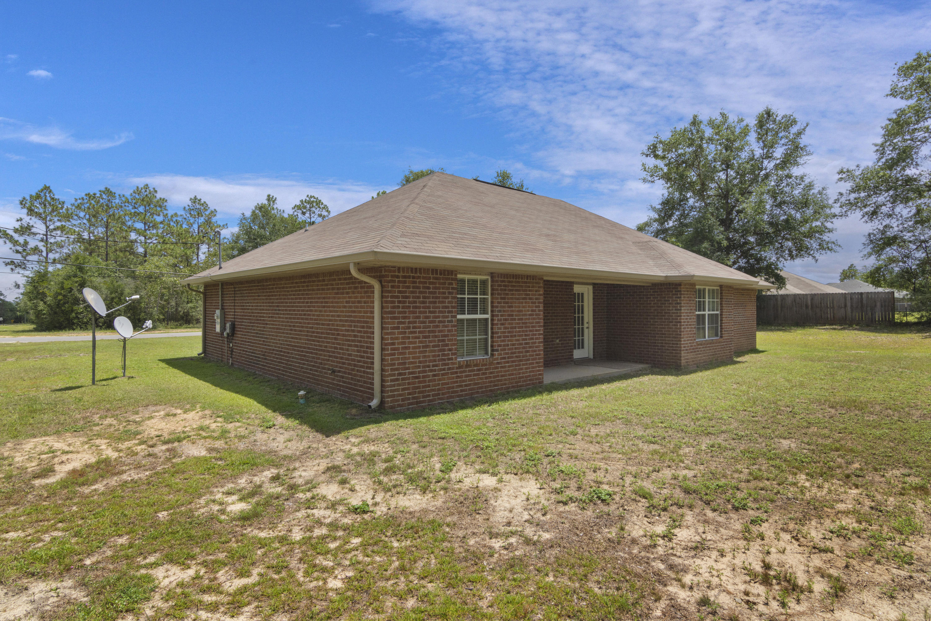 6336 Possum Ridge Road Crestview, FL 32539 - Photo 34 of 40 a view of a house with a yard