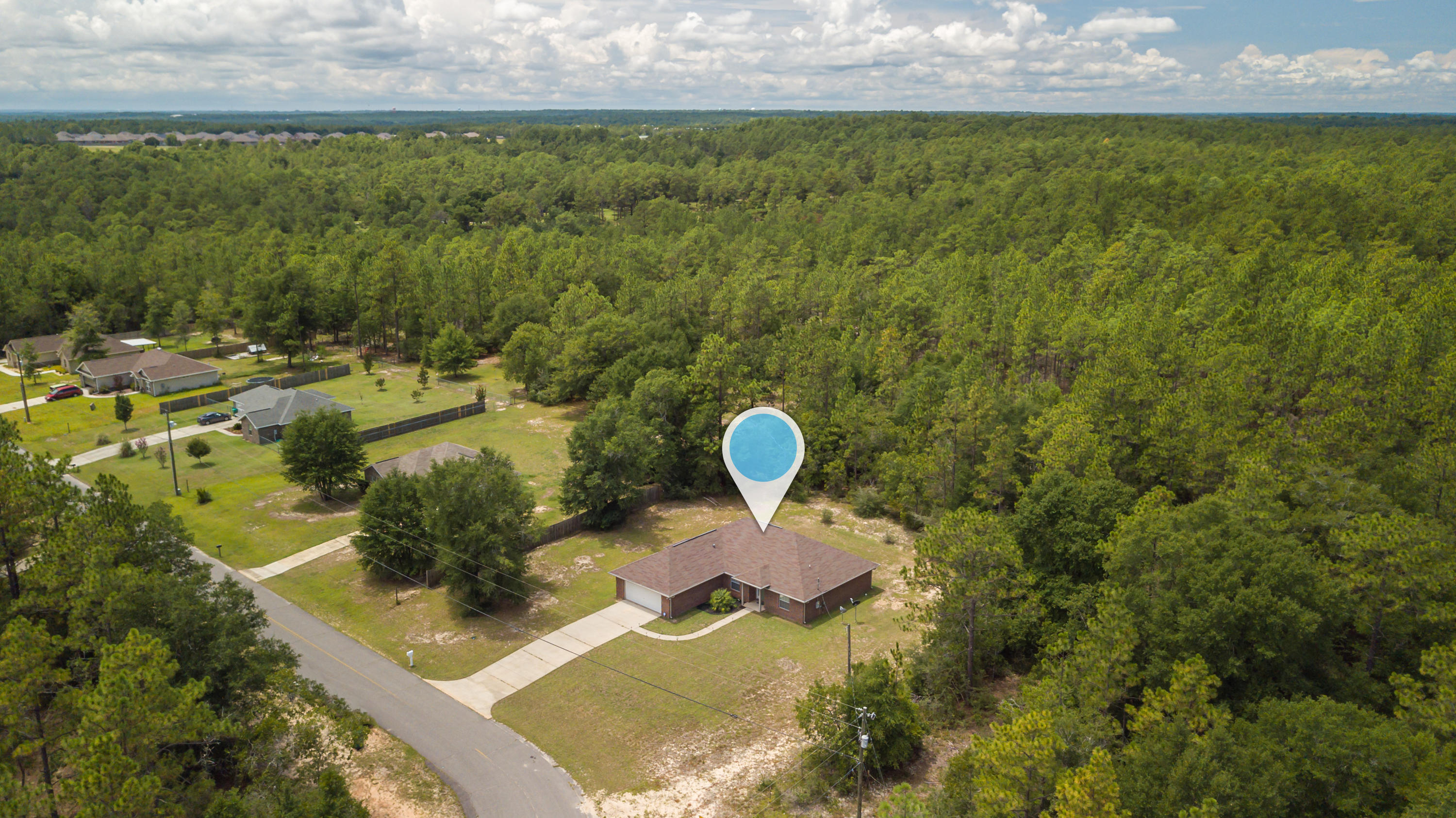 6336 Possum Ridge Road Crestview, FL 32539 - Photo 36 of 40 a backyard of a house with lots of green space