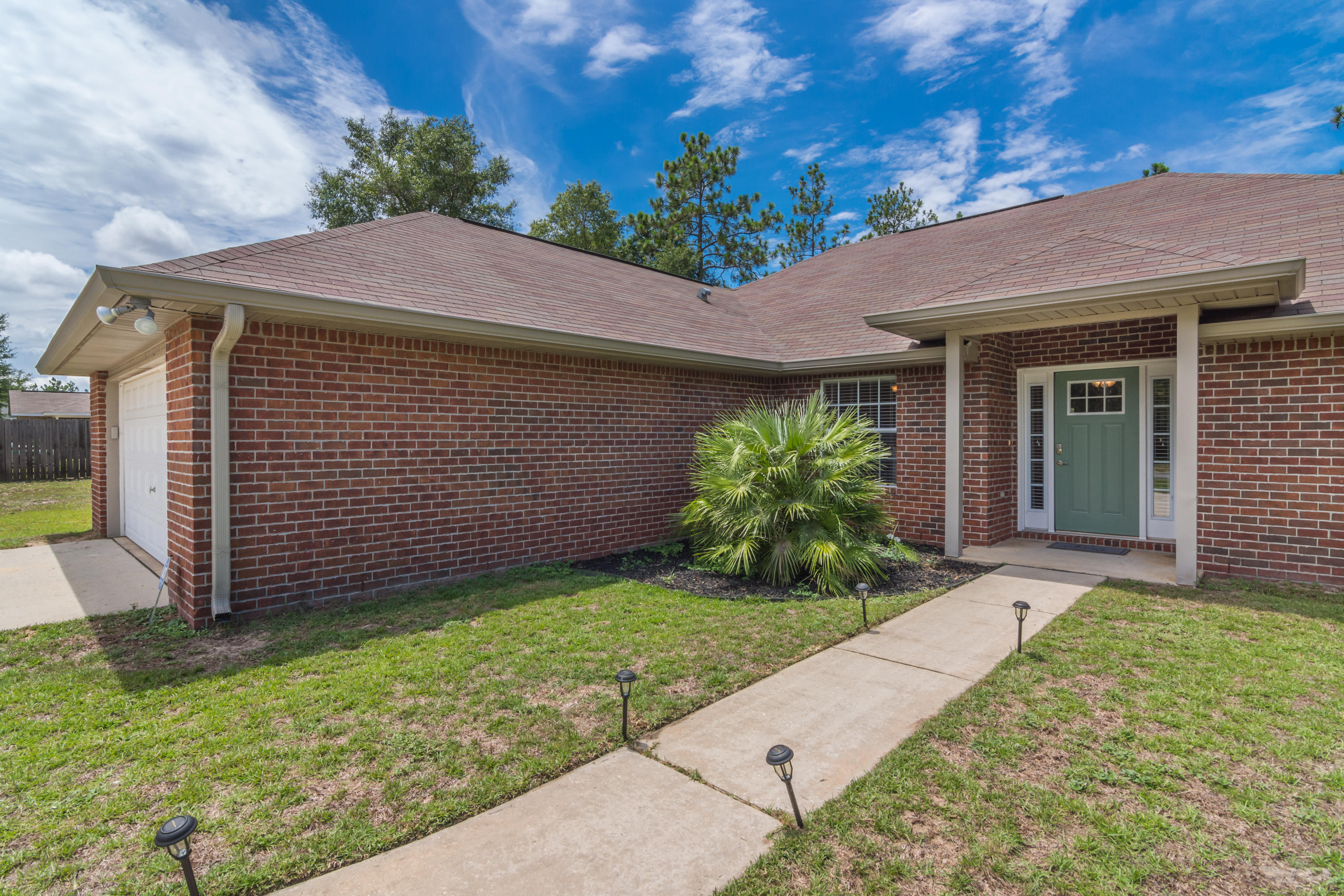6336 Possum Ridge Road Crestview, FL 32539 - Photo 5 of 40 a front view of a house with a garden