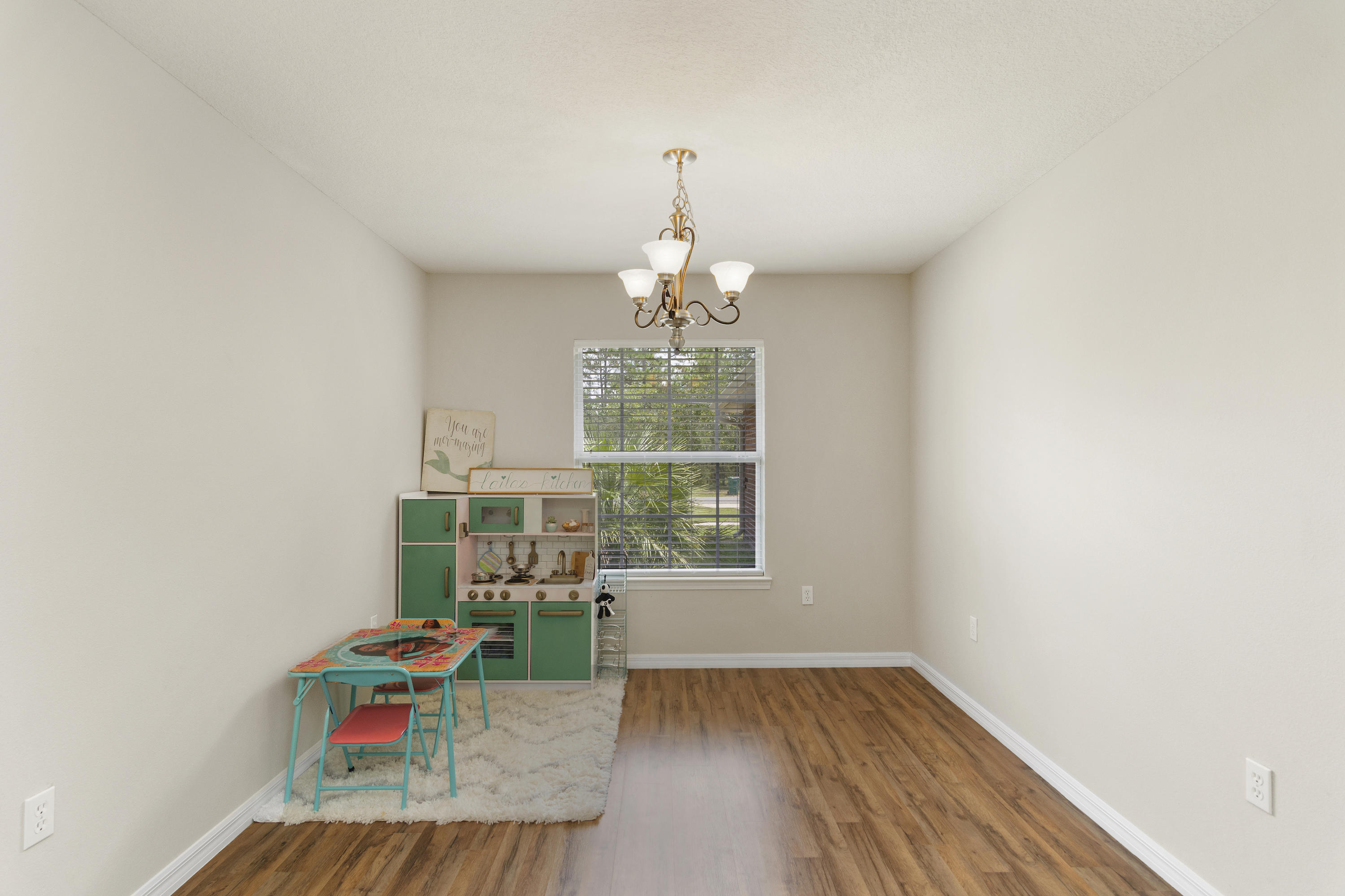 6336 Possum Ridge Road Crestview, FL 32539 - Photo 9 of 40 wooden floor in an empty room with a window