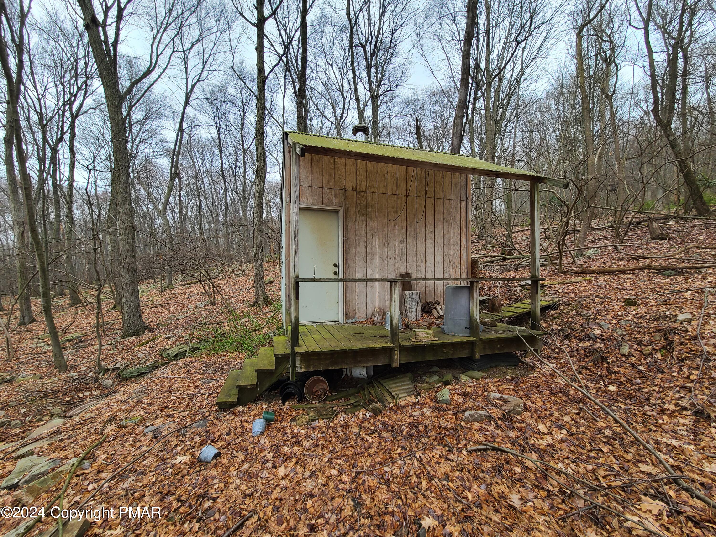 2372 Point Phillips Road Kunkletown, PA 18058 - Photo 1 of 10 a backyard of a house with wooden fence and large trees