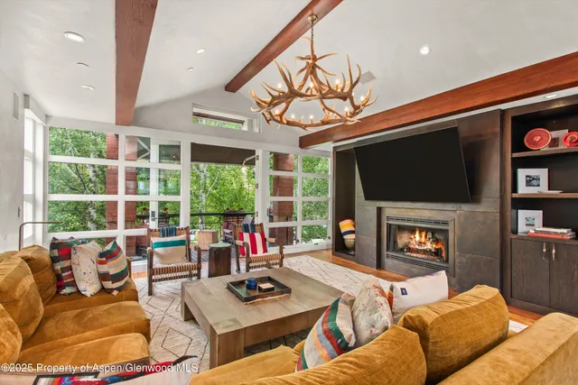 a living room with furniture fireplace and a flat screen tv