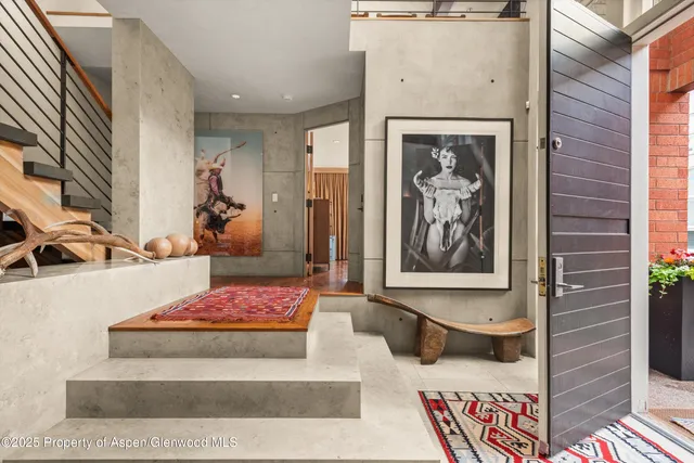 a bedroom with a bed and glass window