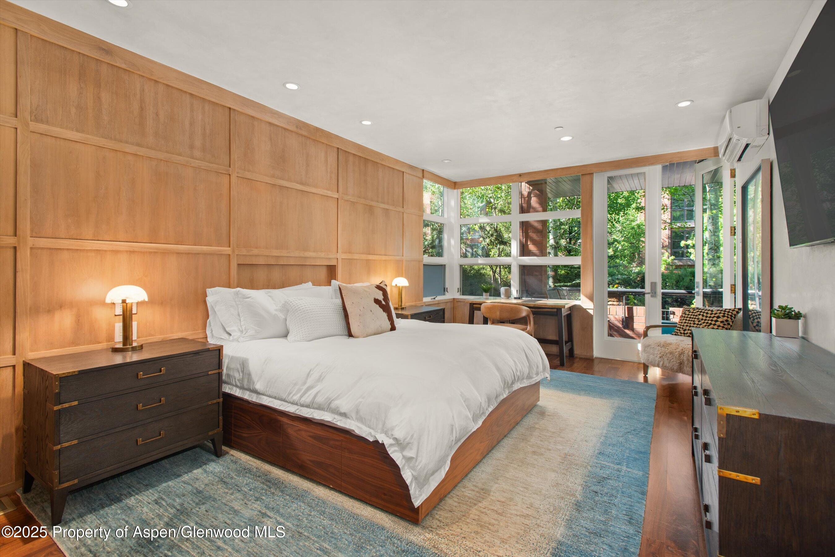 706 East Hyman Avenue, Unit 706 Aspen, CO 81611 - Photo 25 of 46 a bedroom with a bed and large windows