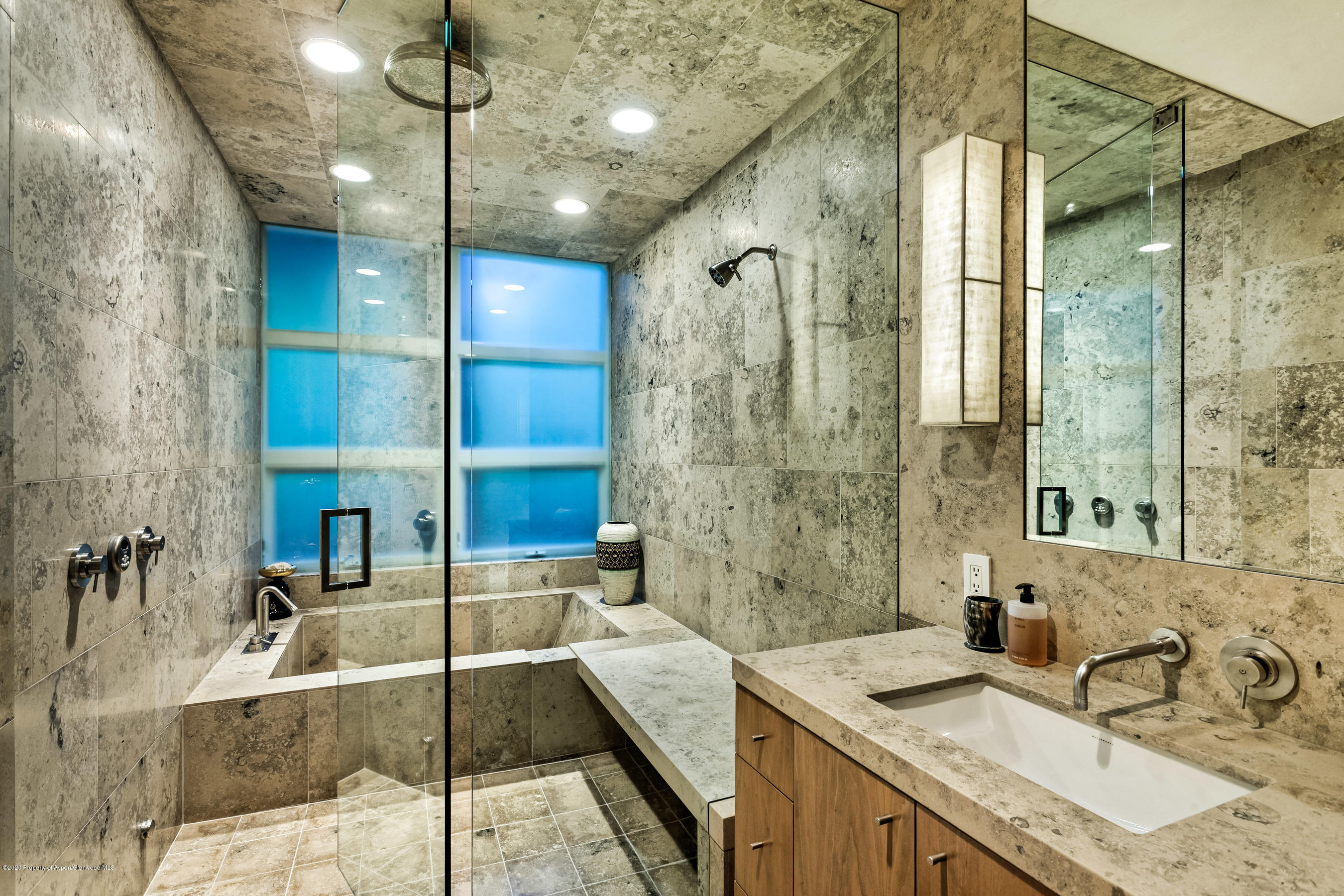 706 East Hyman Avenue, Unit 706 Aspen, CO 81611 - Photo 28 of 46 a bathroom with tub sink and mirror