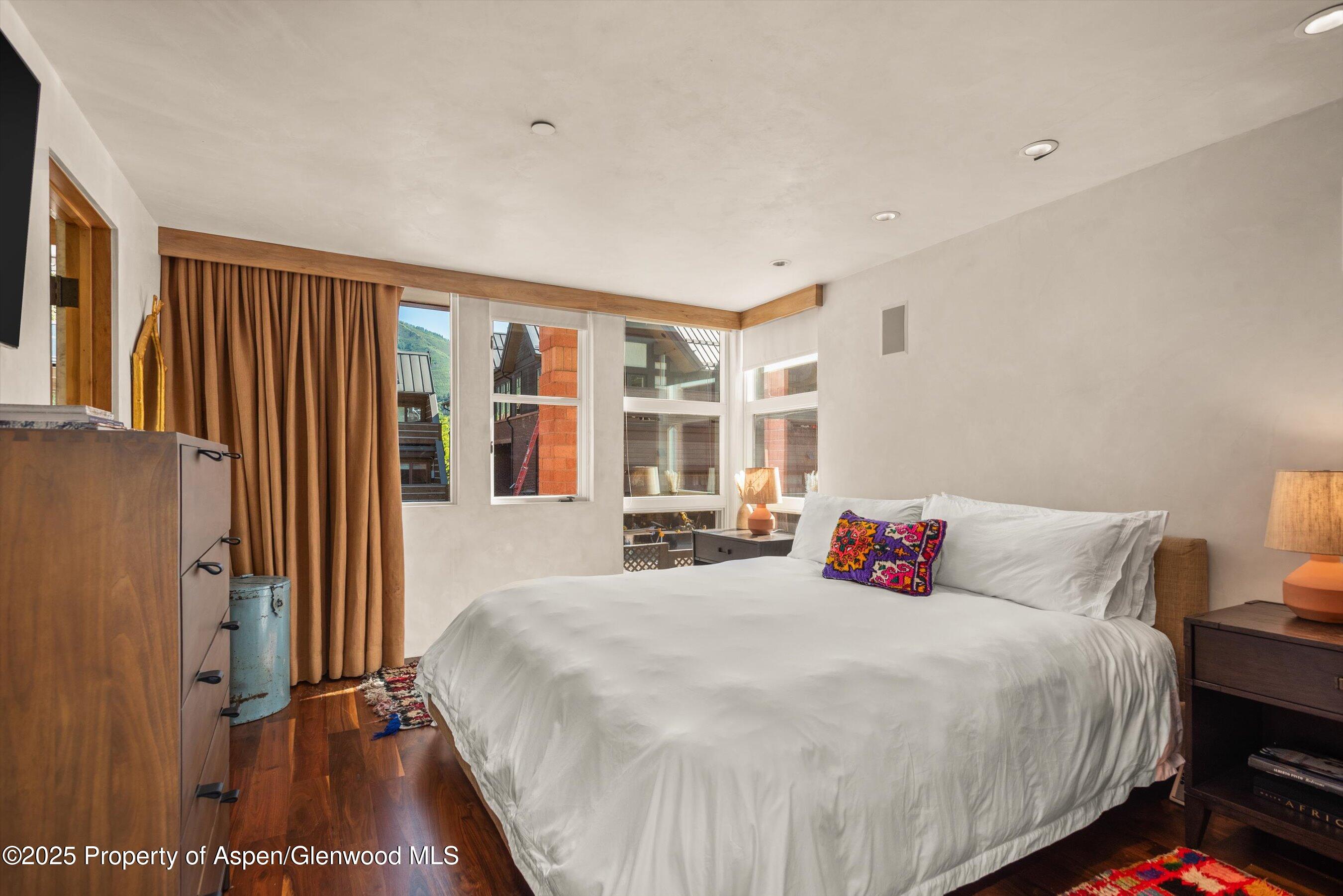 706 East Hyman Avenue, Unit 706 Aspen, CO 81611 - Photo 30 of 46 a bedroom with a bed and a large window