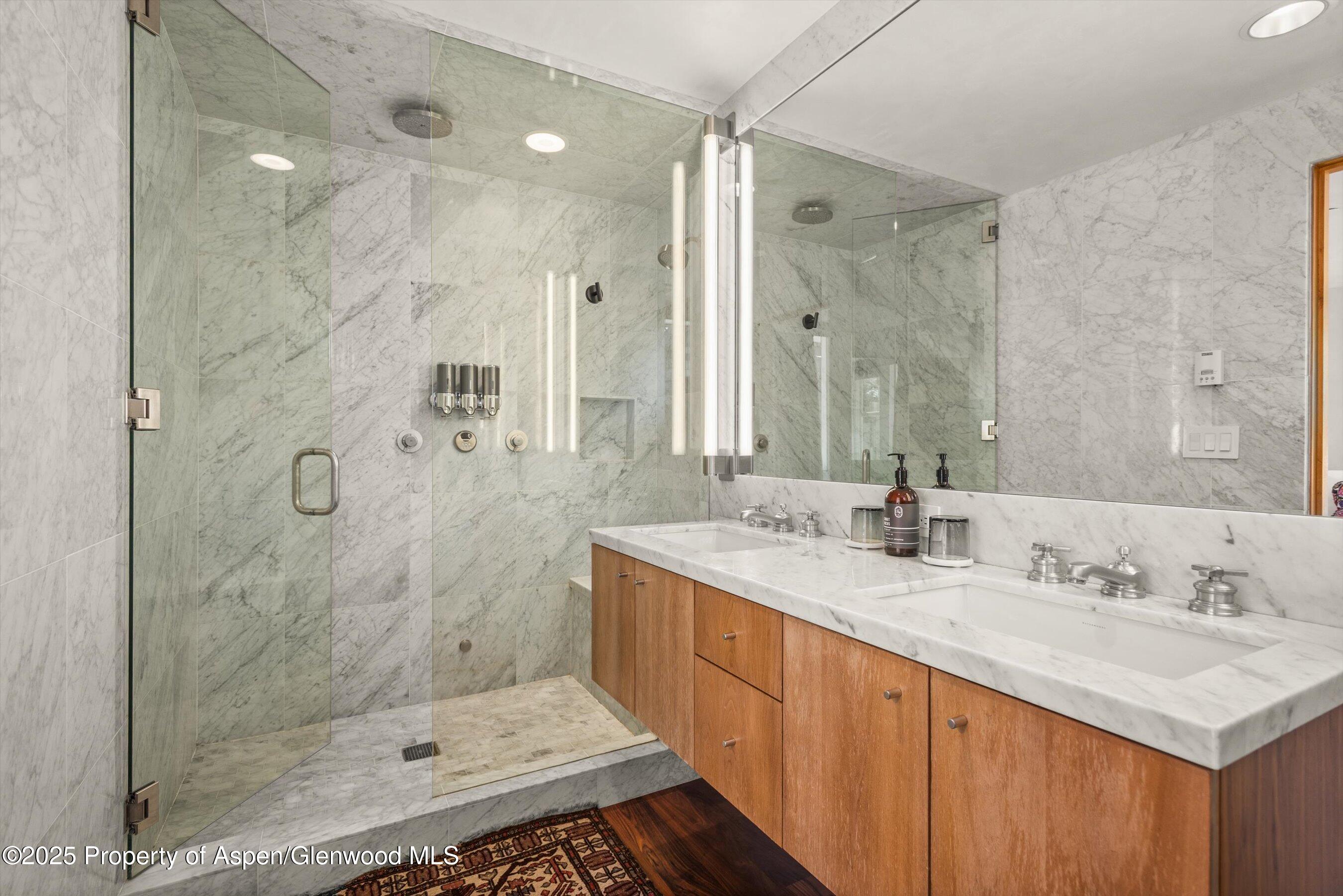 706 East Hyman Avenue, Unit 706 Aspen, CO 81611 - Photo 31 of 46 a bathroom with a double vanity sink mirror and shower
